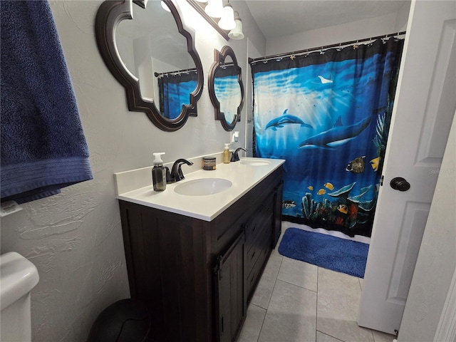 bathroom with tile patterned floors, vanity, and toilet