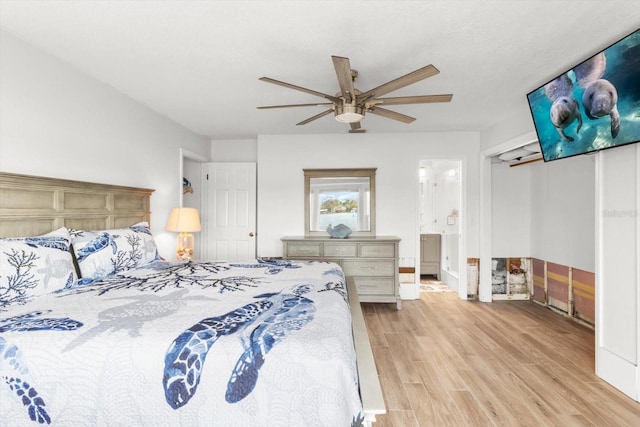 bedroom featuring connected bathroom, ceiling fan, and light hardwood / wood-style flooring