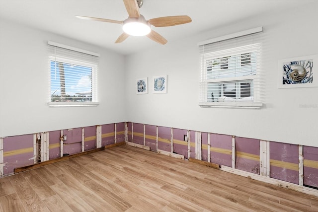 spare room with light hardwood / wood-style flooring and ceiling fan