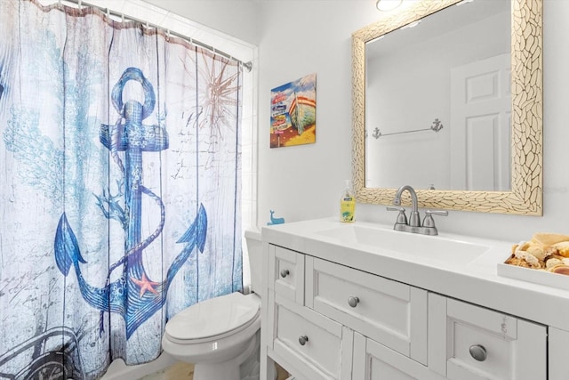 bathroom featuring vanity, curtained shower, and toilet