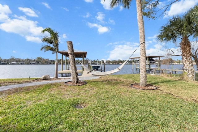 view of dock featuring a water view and a lawn