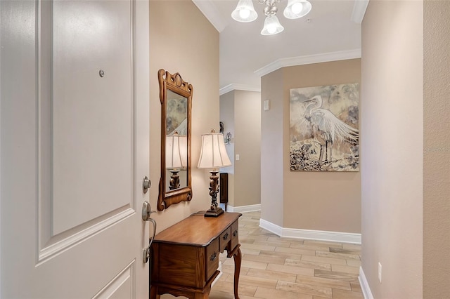 interior space featuring light hardwood / wood-style floors, ornamental molding, and a chandelier