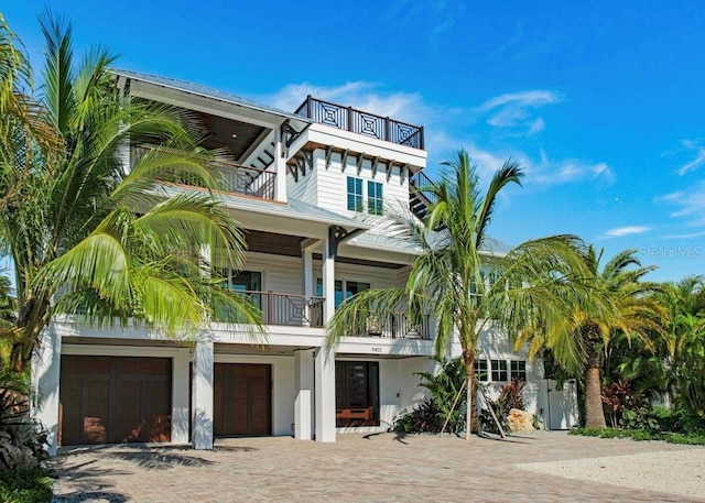 view of front facade featuring a garage and a balcony