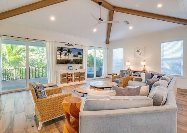 living room with light hardwood / wood-style flooring, lofted ceiling with beams, and ceiling fan