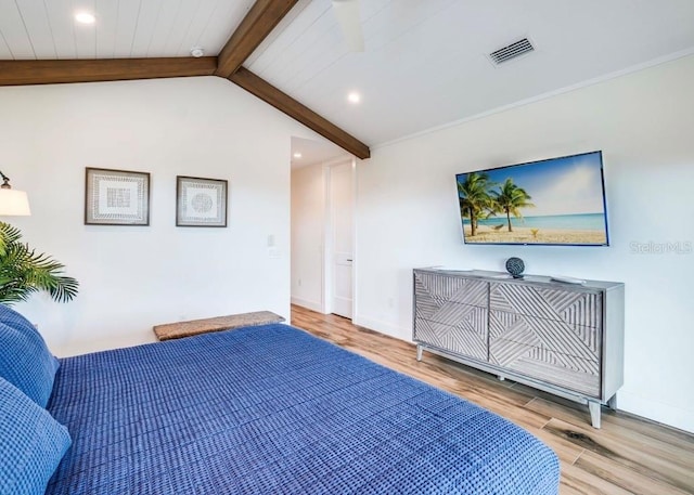 bedroom featuring hardwood / wood-style flooring and lofted ceiling with beams