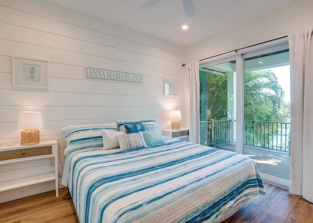 bedroom featuring ceiling fan, access to exterior, and hardwood / wood-style floors