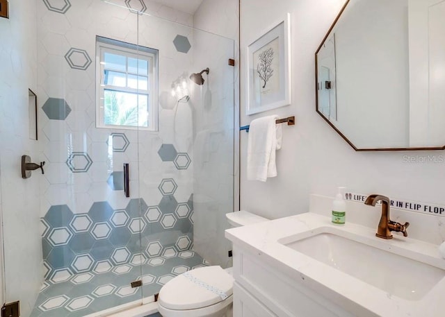 bathroom with vanity, an enclosed shower, and toilet