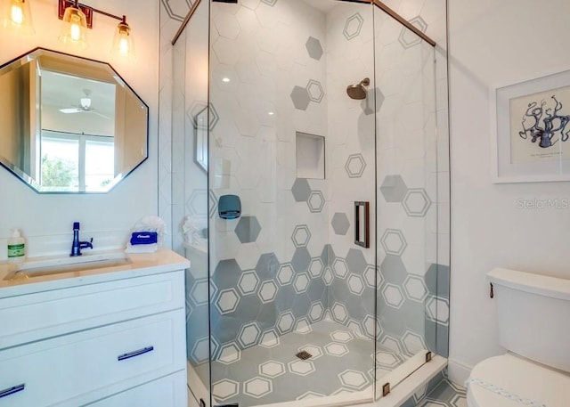 bathroom with vanity, toilet, and a shower with shower door