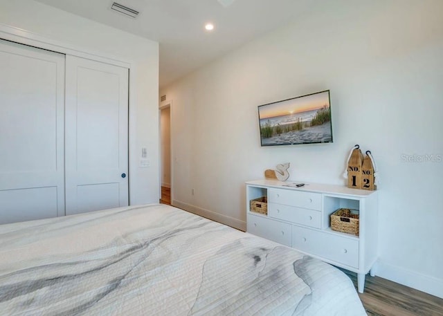 bedroom featuring wood-type flooring and a closet