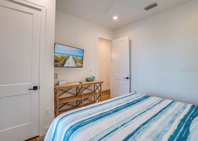 bedroom with hardwood / wood-style floors