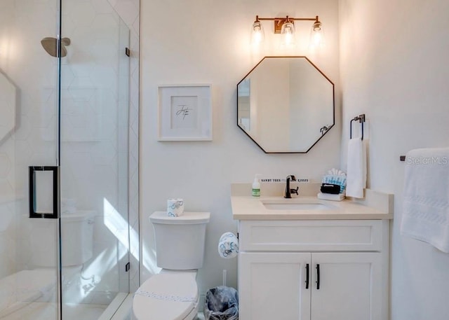 bathroom with vanity, toilet, and walk in shower