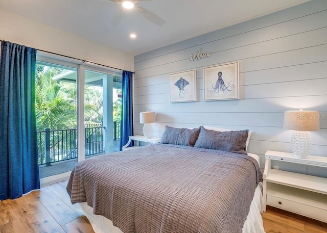 bedroom featuring access to exterior, light hardwood / wood-style floors, and ceiling fan