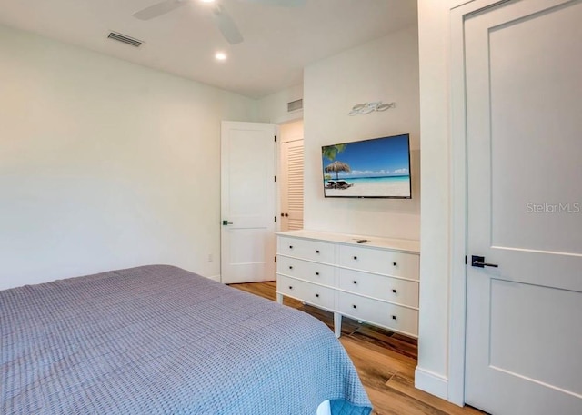 bedroom with ceiling fan and light wood-type flooring