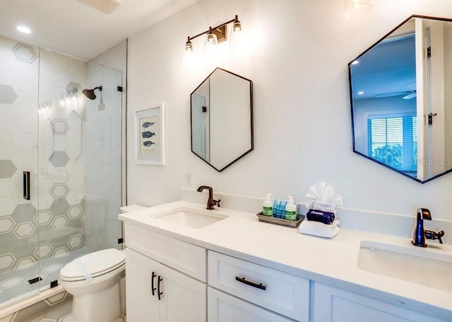 bathroom with vanity, toilet, and an enclosed shower