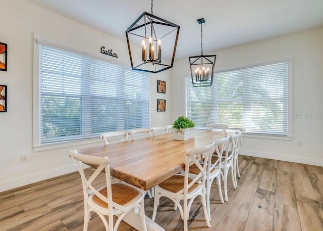 dining area featuring an inviting chandelier and wood-type flooring