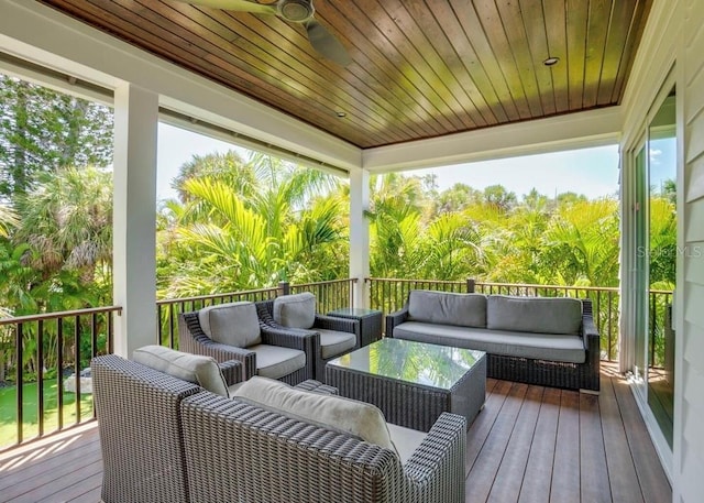 deck with outdoor lounge area and ceiling fan