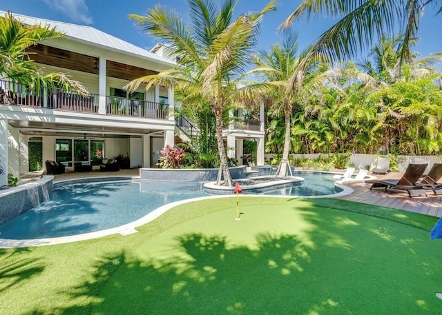 view of swimming pool with a hot tub and pool water feature