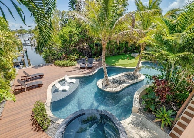 view of pool featuring an in ground hot tub and a deck