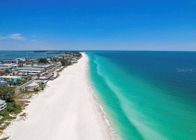 birds eye view of property with a water view and a view of the beach