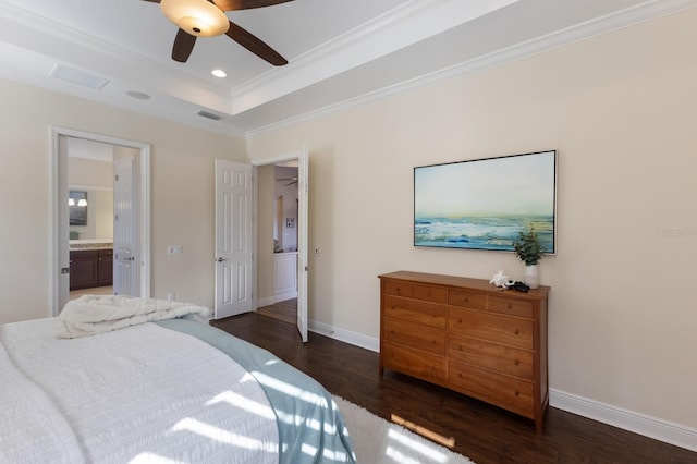 bedroom featuring ensuite bath, ceiling fan, a raised ceiling, dark hardwood / wood-style floors, and crown molding