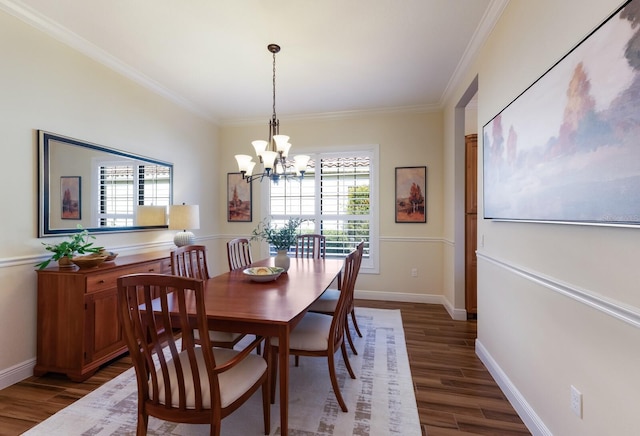 dining room featuring ornamental molding, dark wood-type flooring, and a chandelier