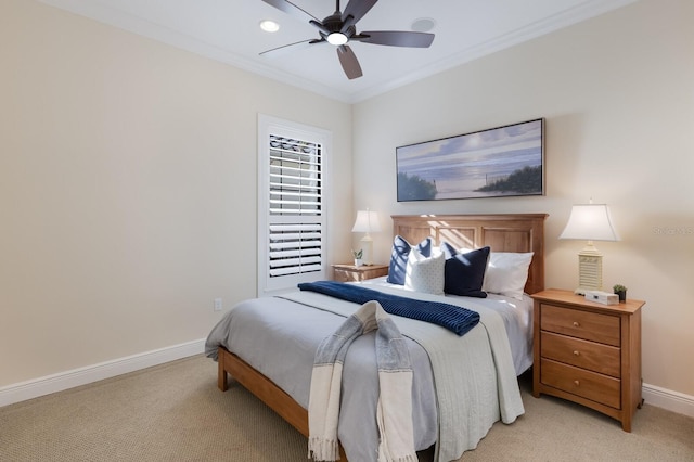 carpeted bedroom with ceiling fan and ornamental molding