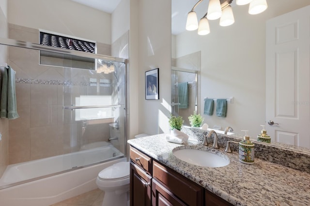 full bathroom with tile patterned floors, vanity, toilet, and enclosed tub / shower combo