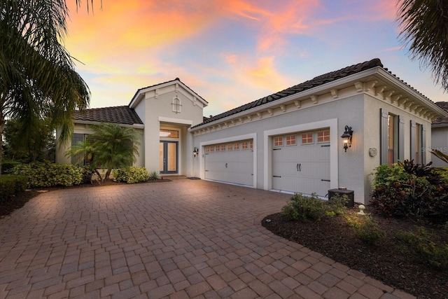 mediterranean / spanish house featuring a garage