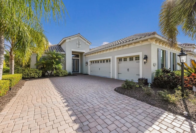 mediterranean / spanish house featuring a garage