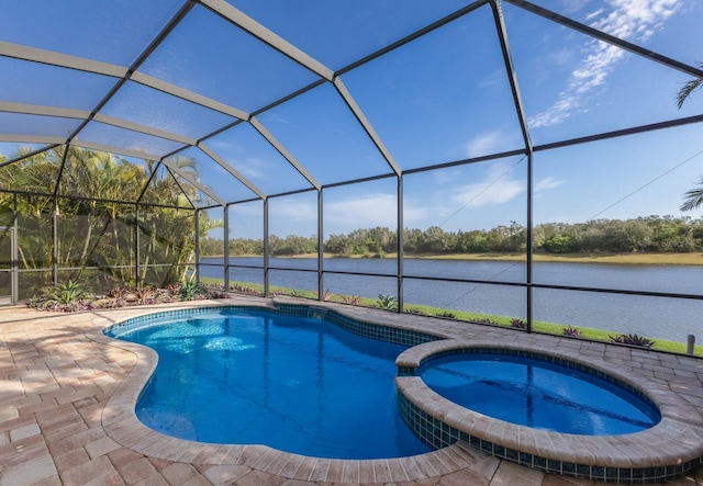 view of pool featuring a patio, a lanai, a water view, and an in ground hot tub