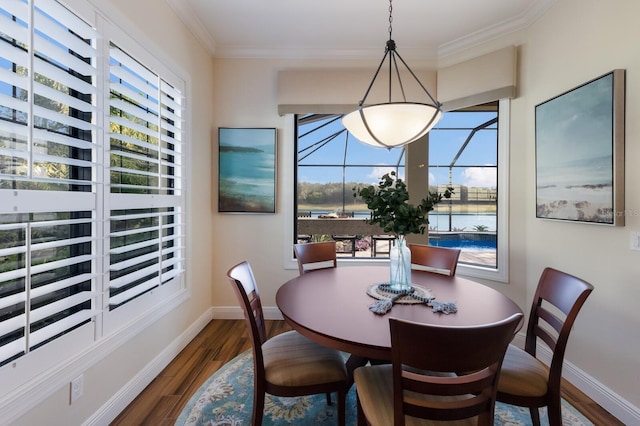 dining area with crown molding, hardwood / wood-style flooring, and plenty of natural light