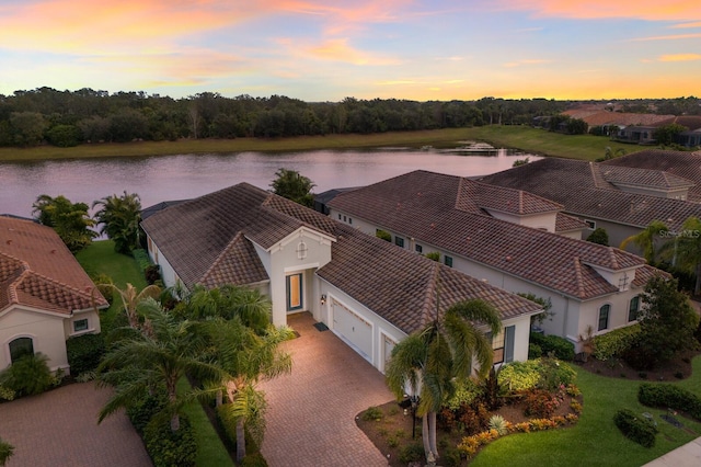 aerial view at dusk with a water view