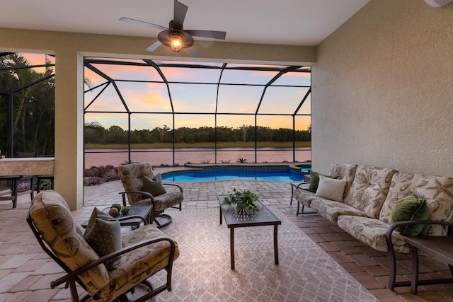 patio terrace at dusk featuring an outdoor living space, an outdoor pool, and glass enclosure