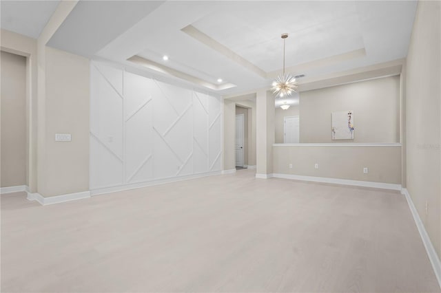 interior space featuring a chandelier and a tray ceiling