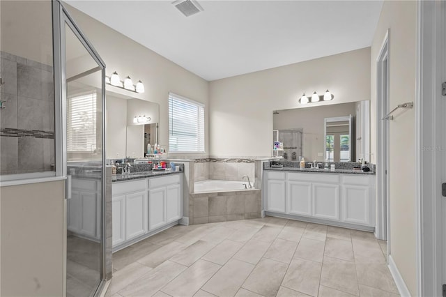 bathroom with tile patterned floors, separate shower and tub, and vanity