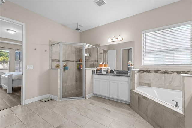 bathroom with tile patterned floors, vanity, and plus walk in shower