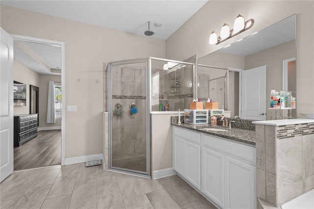 bathroom featuring vanity, tile patterned floors, and a shower with shower door