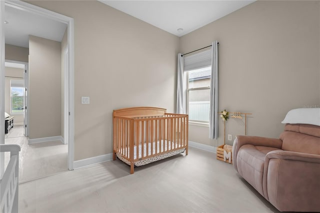 bedroom featuring a crib and multiple windows