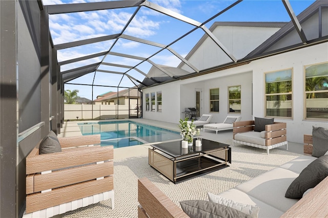 view of pool featuring outdoor lounge area, glass enclosure, area for grilling, and a patio area