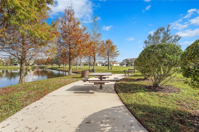 view of property's community featuring a yard and a water view