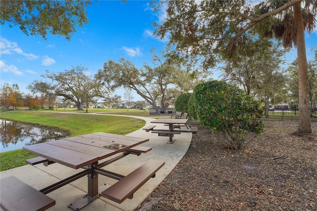 surrounding community featuring a water view and a yard