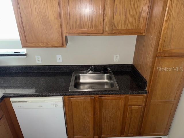 kitchen featuring white dishwasher and sink