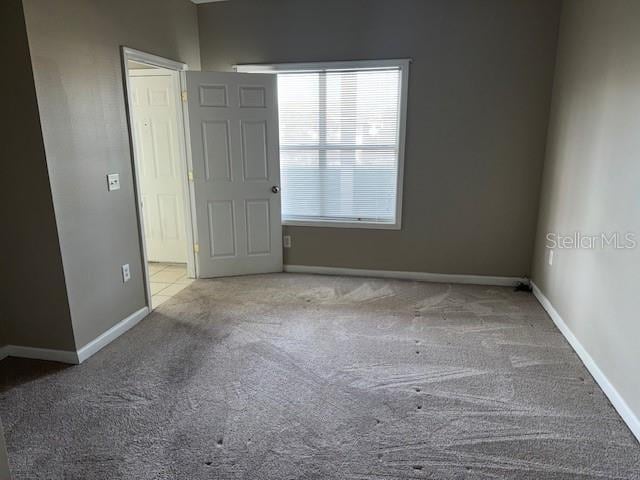 unfurnished room with light colored carpet