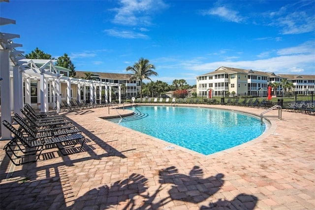 view of swimming pool with a patio and a pergola