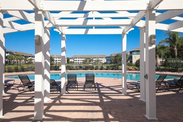 view of pool with a pergola and a patio area