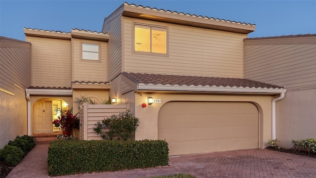 mediterranean / spanish-style home with a garage