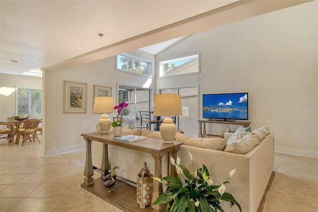 tiled living room featuring vaulted ceiling