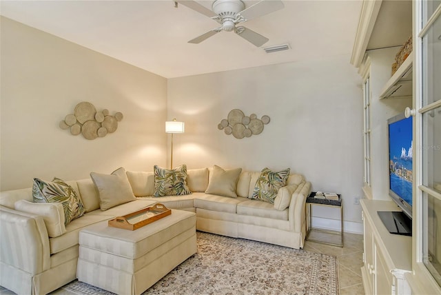 living room with light tile patterned floors and ceiling fan