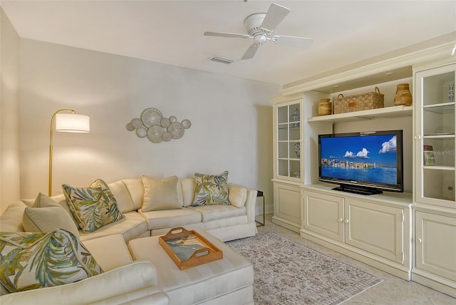 living room featuring light tile patterned floors and ceiling fan