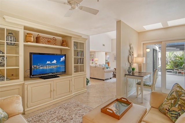 tiled living room featuring ceiling fan and vaulted ceiling